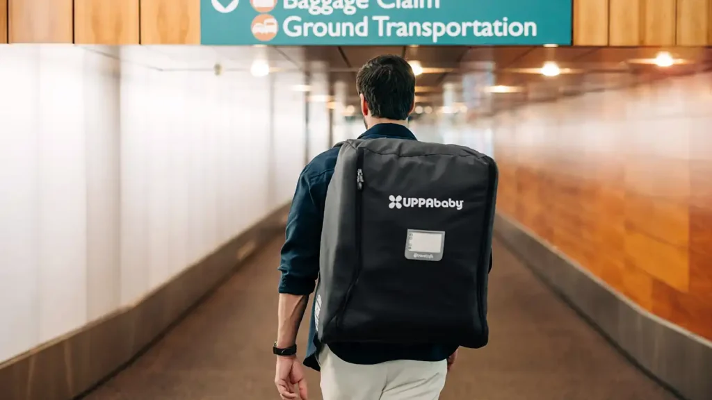Parent walking through airport with travel bag